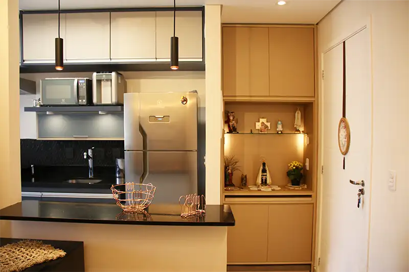 Entrada de apartamento com armário, oratório e balcão sob medida Entrada de apartamento com armário, oratório, balcão americano e cozinha com móveis sob medida
